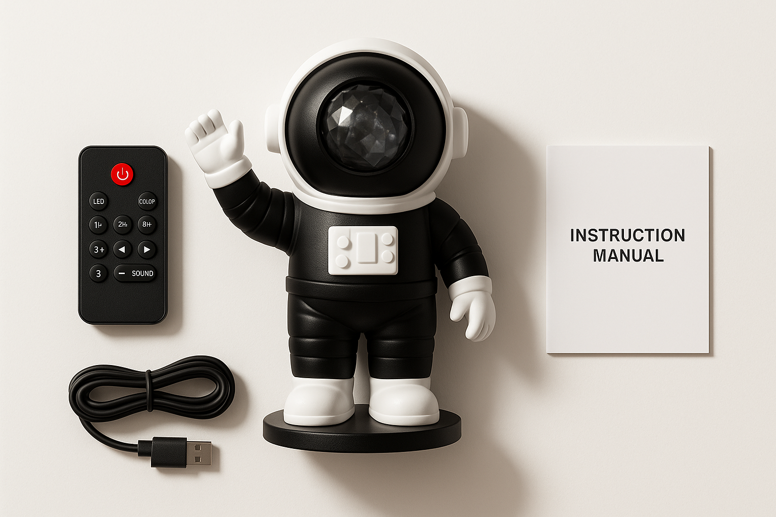 Studio-quality flat-lay of a black and white astronaut-shaped galaxy projector with all included accessories: remote control, USB cable, instruction manual. White background, soft shadows, clean modern presentation. Perfect for ecommerce product page. 3D product rendering style, high clarity, high realism.